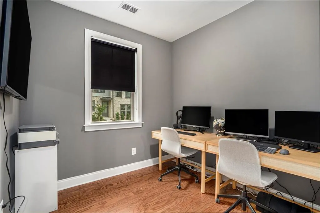 Home office with wood finished floors and baseboards