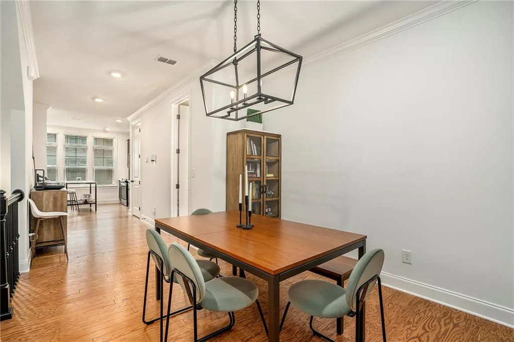 Dining space featuring crown molding, light wood-type flooring, recessed lighting, and a chandelier