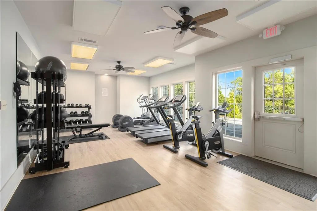 Workout area with wood finished floors and ceiling fan