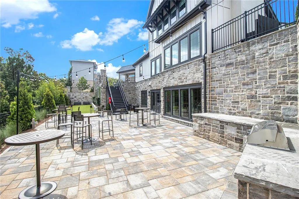View of patio / terrace with stairs and a grill