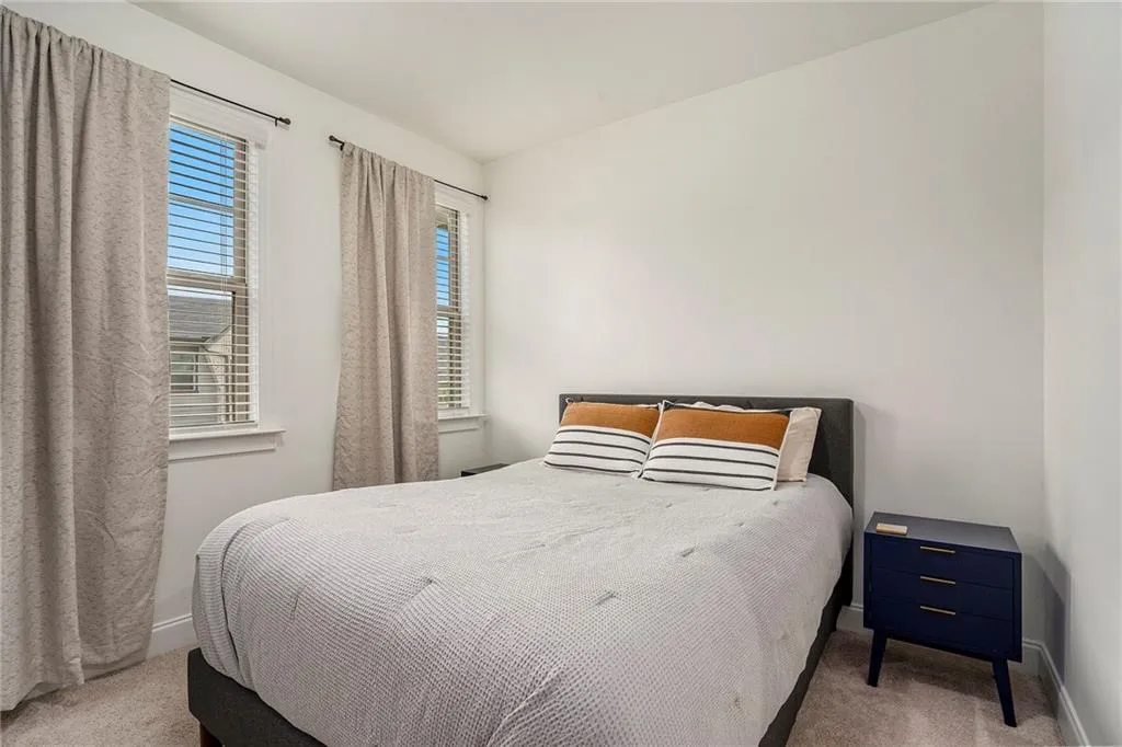 Bedroom featuring carpet floors and baseboards