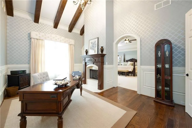 Office area with ceiling fan, high vaulted ceiling, beam ceiling, and dark hardwood / wood-style floors