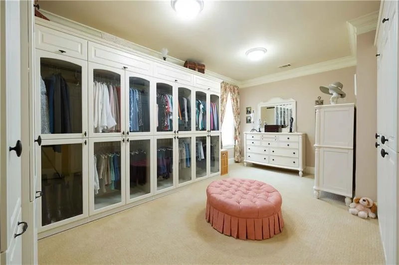 Living area featuring ornamental molding and light carpet