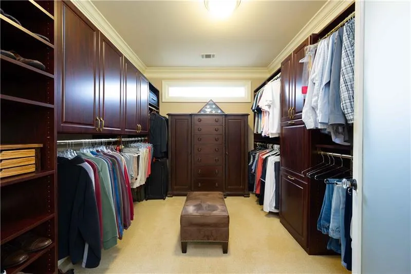 Spacious closet featuring light carpet