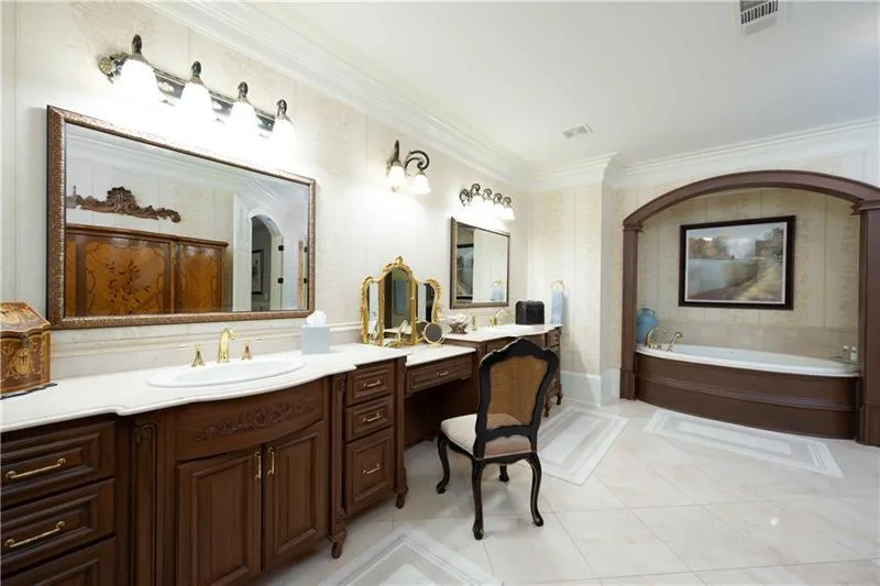Bathroom featuring a bath, ornamental molding, tile flooring, and vanity
