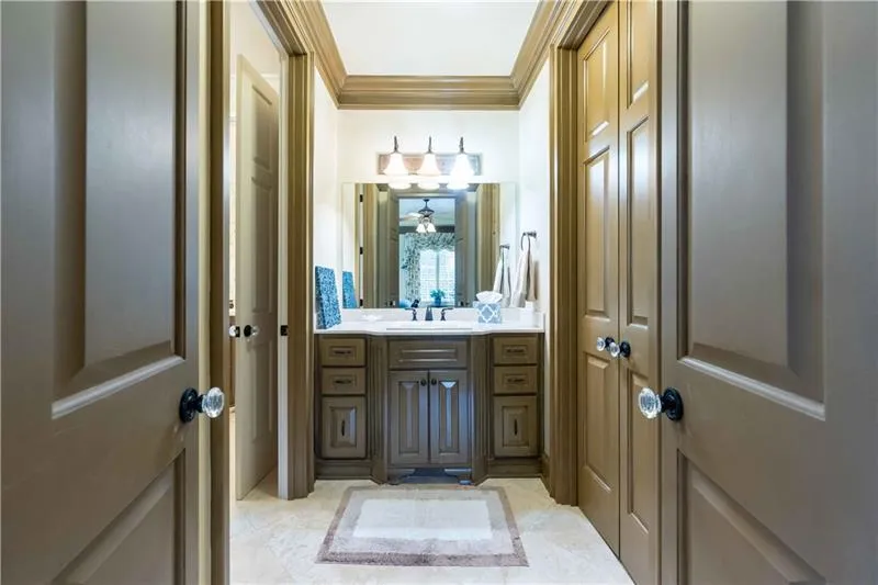 Bathroom featuring crown molding, ceiling fan, tile floors, and large vanity