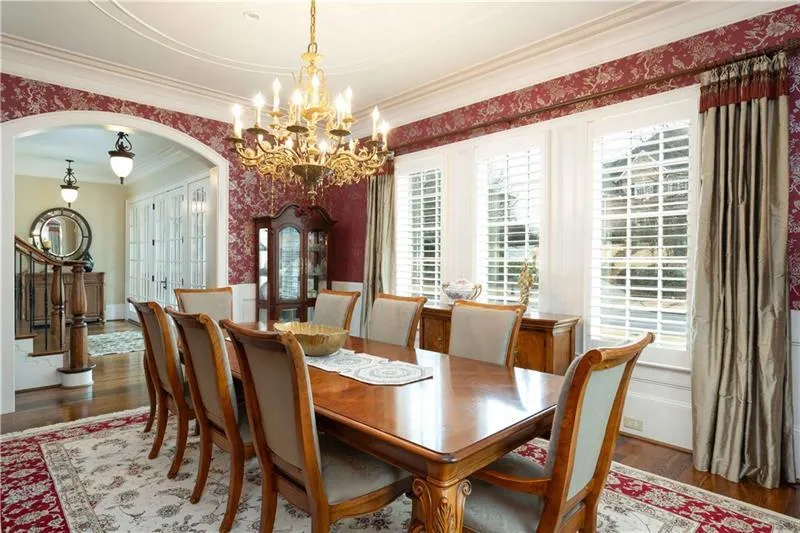 Dining area featuring crown molding, dark hardwood / wood-style flooring, and a chandelier