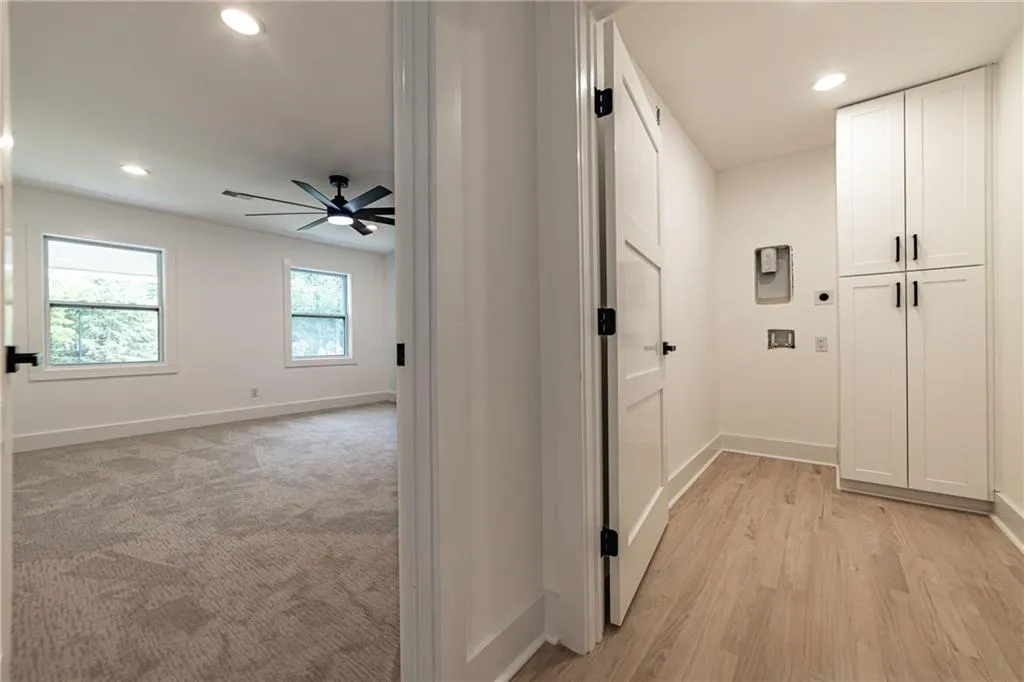 Hall with recessed lighting and light wood-style flooring