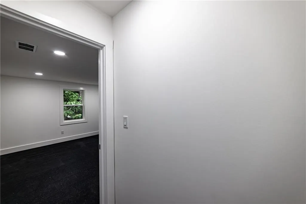 Empty room with recessed lighting and baseboards