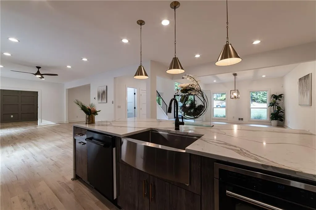 Kitchen with light wood-style floors, recessed lighting, dishwasher, open floor plan, and pendant lighting