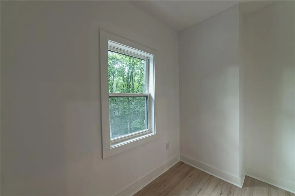 Unfurnished room with baseboards and light wood finished floors