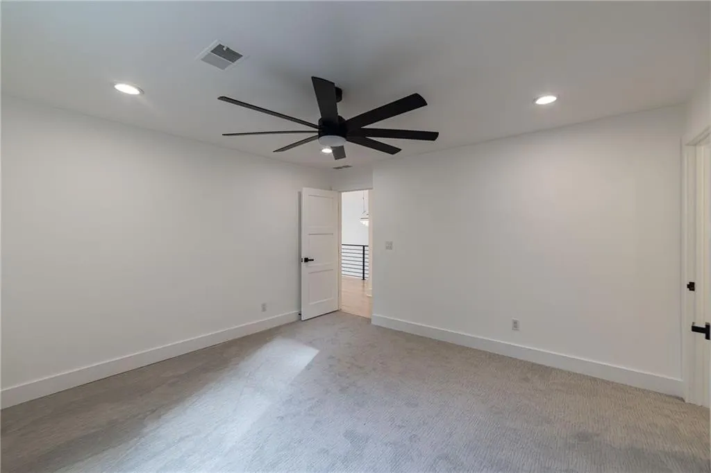 Empty room with recessed lighting, light carpet, and a ceiling fan