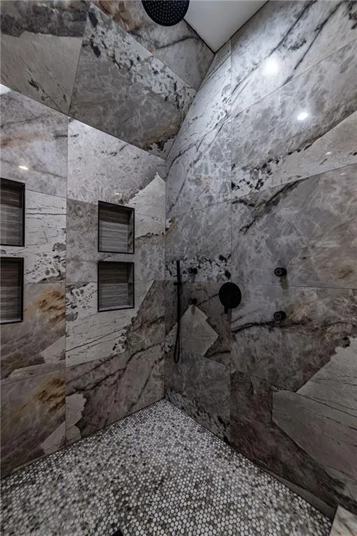 Bathroom featuring a tile shower