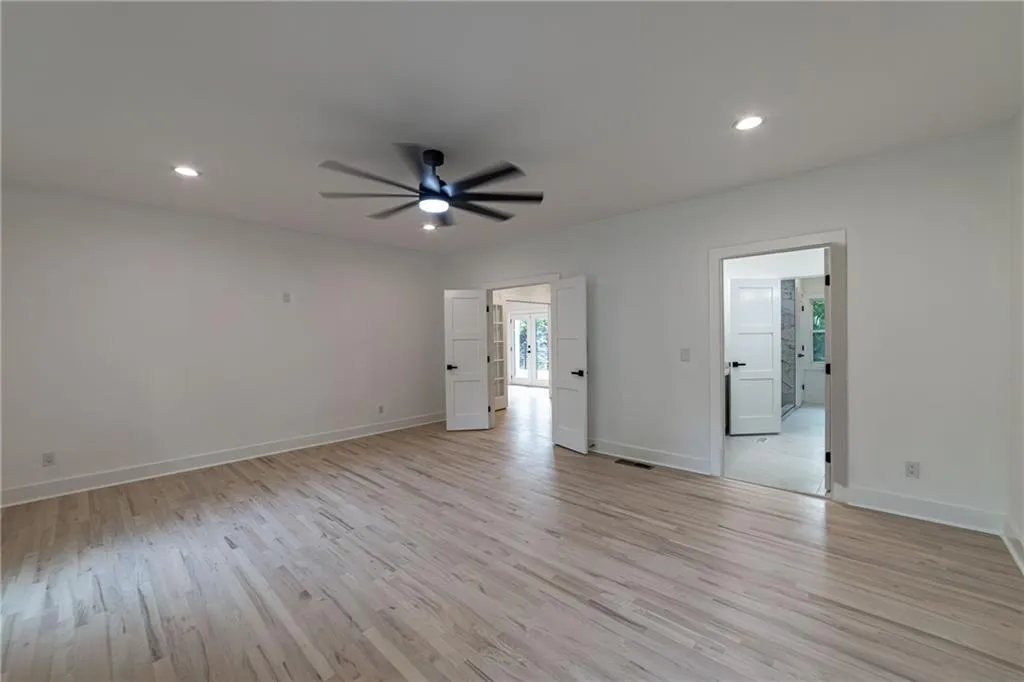 Empty room featuring light wood-type flooring, recessed lighting, and a ceiling fan