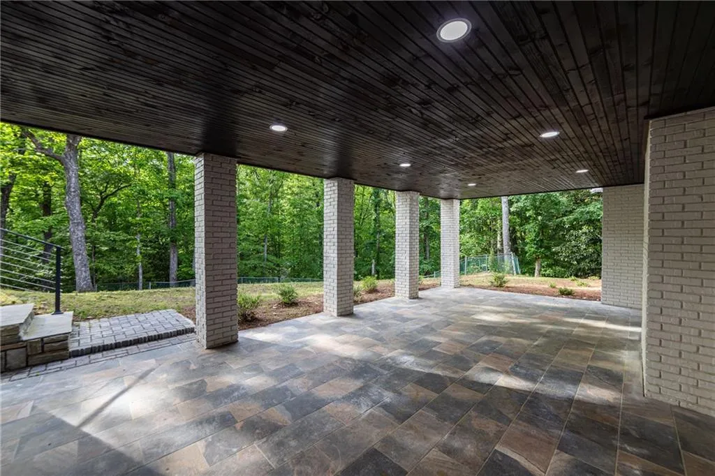 View of patio / terrace featuring view of wooded area