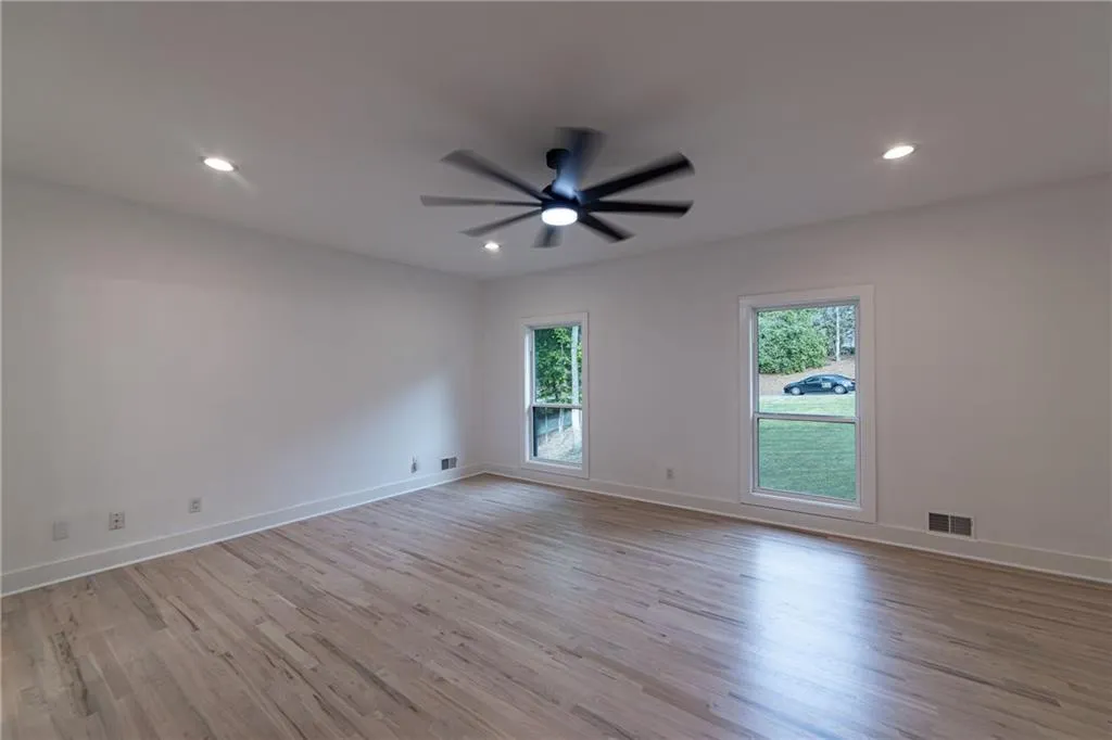 Unfurnished room with light wood finished floors, recessed lighting, and a ceiling fan