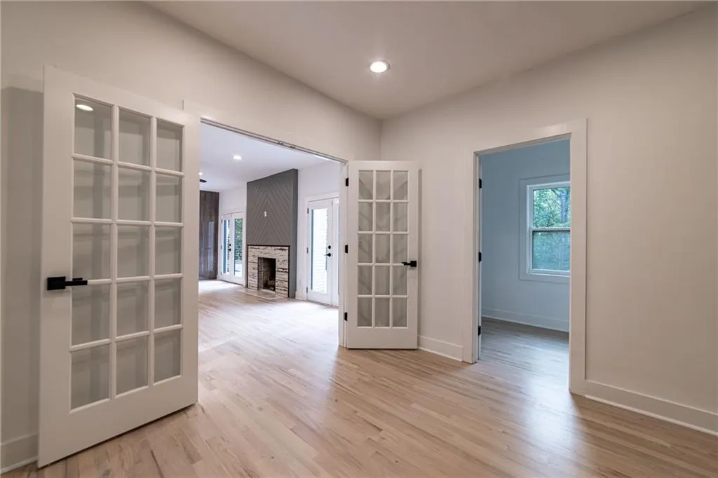 Hall featuring light wood finished floors, recessed lighting, and french doors