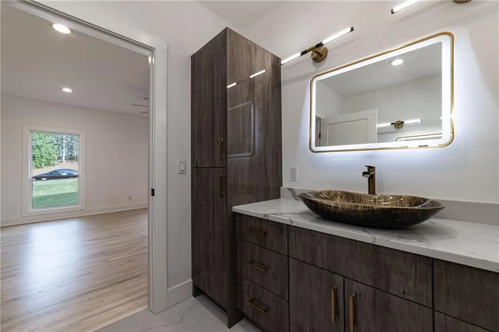 Bathroom featuring recessed lighting, vanity, and marble finish floors