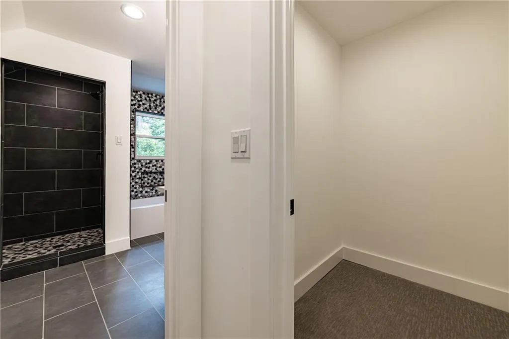 Full bathroom with tiled shower, tile patterned floors, and recessed lighting