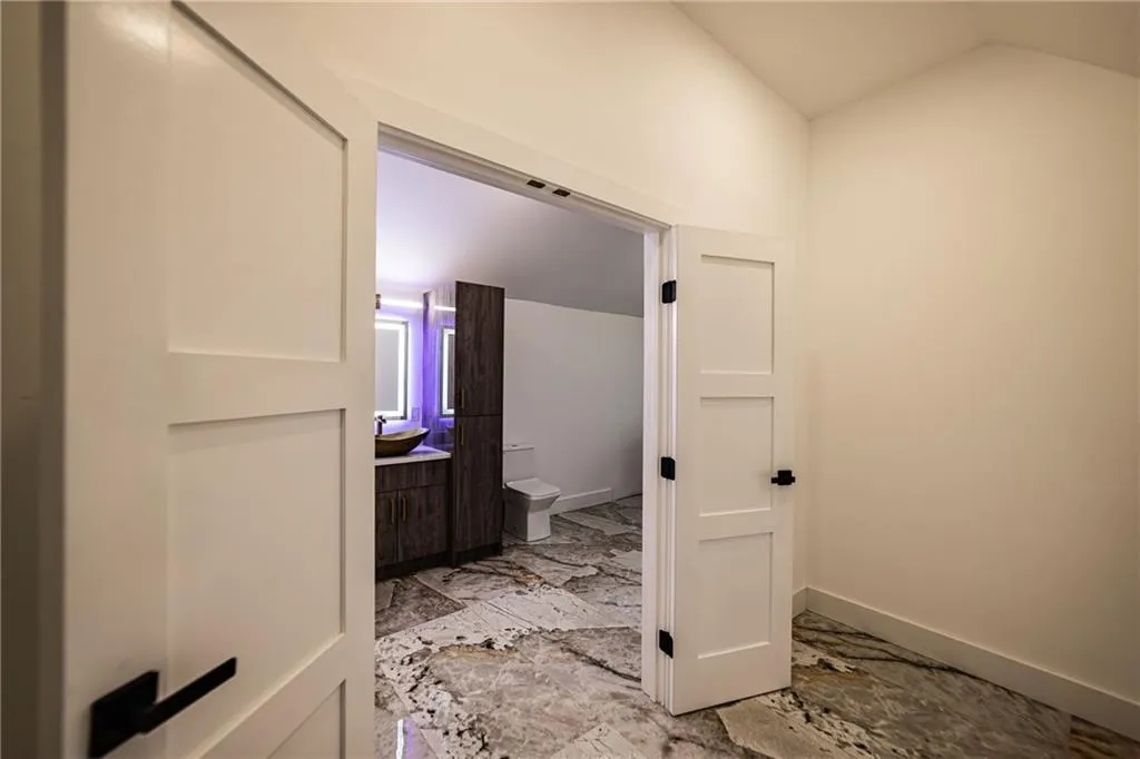 Bathroom featuring marble finish floors and vanity