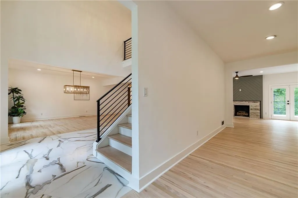 Hall featuring recessed lighting, light wood finished floors, stairway, and french doors