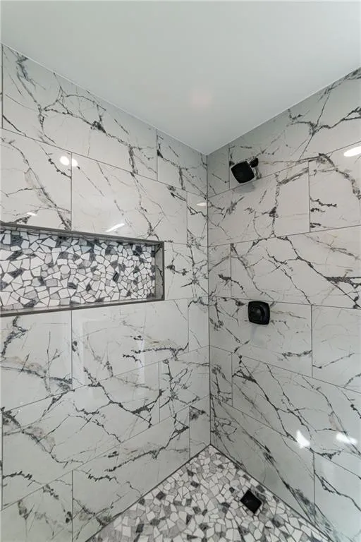 Bathroom featuring a tile shower