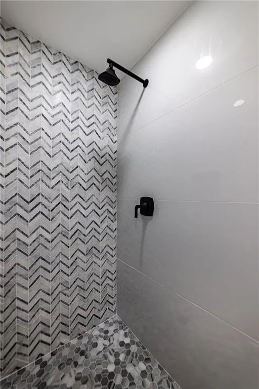 Full bath featuring tiled shower