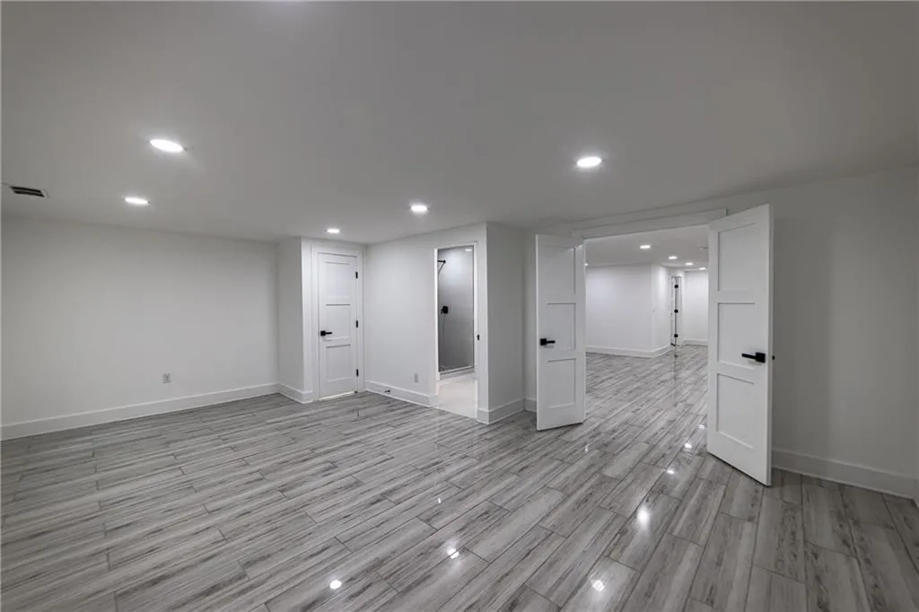 Finished below grade area featuring recessed lighting and wood finish floors