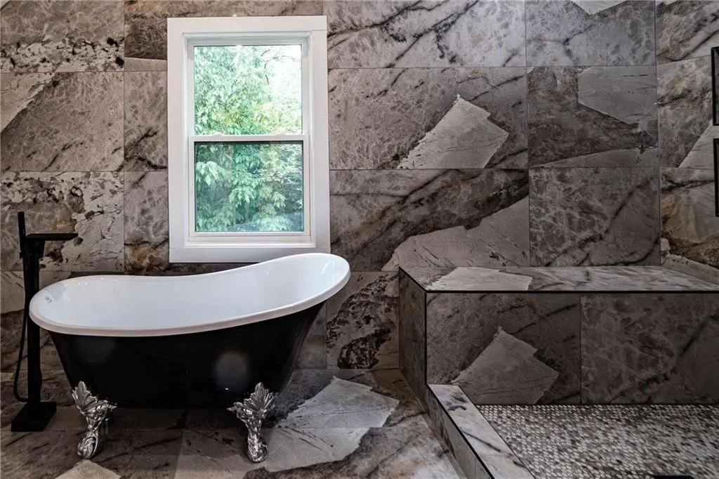 Full bath featuring a soaking tub