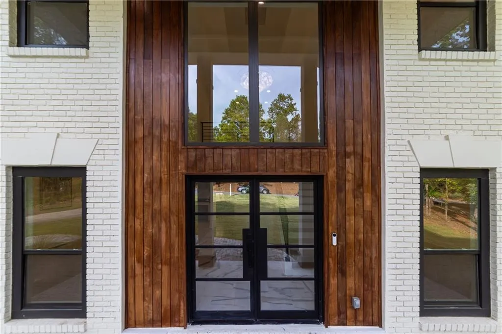 Property entrance with brick siding and french doors