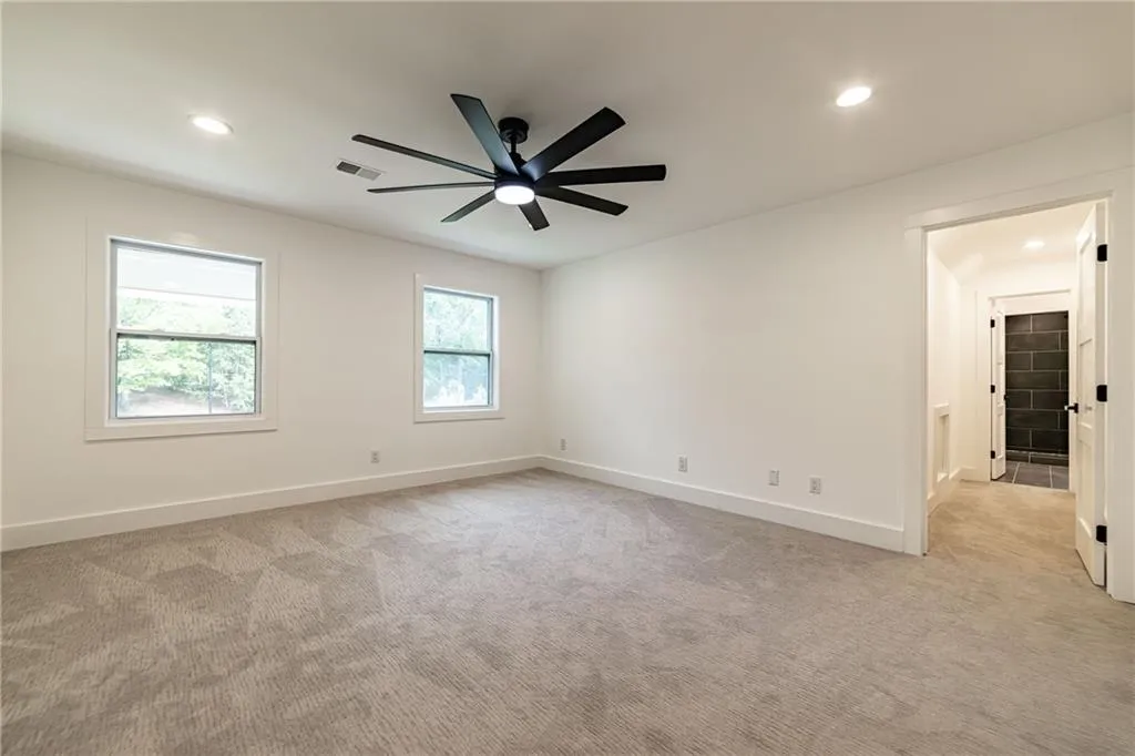 Spare room featuring recessed lighting, light colored carpet, and ceiling fan