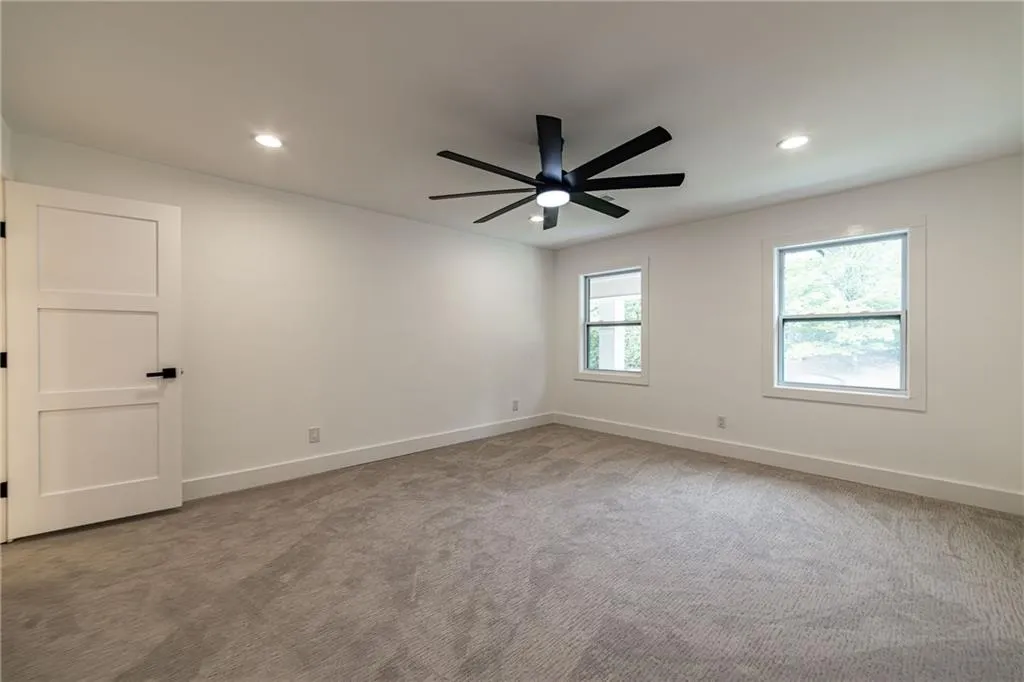 Carpeted empty room with recessed lighting and a ceiling fan