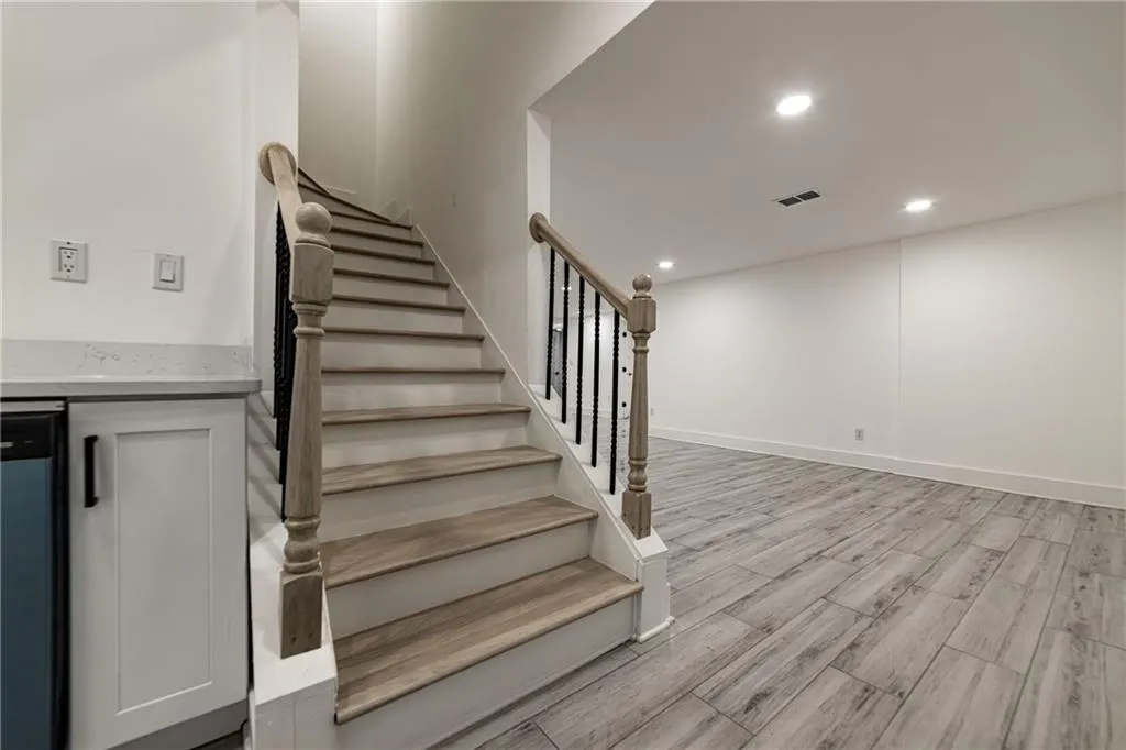 Staircase featuring recessed lighting and wood tiled floors