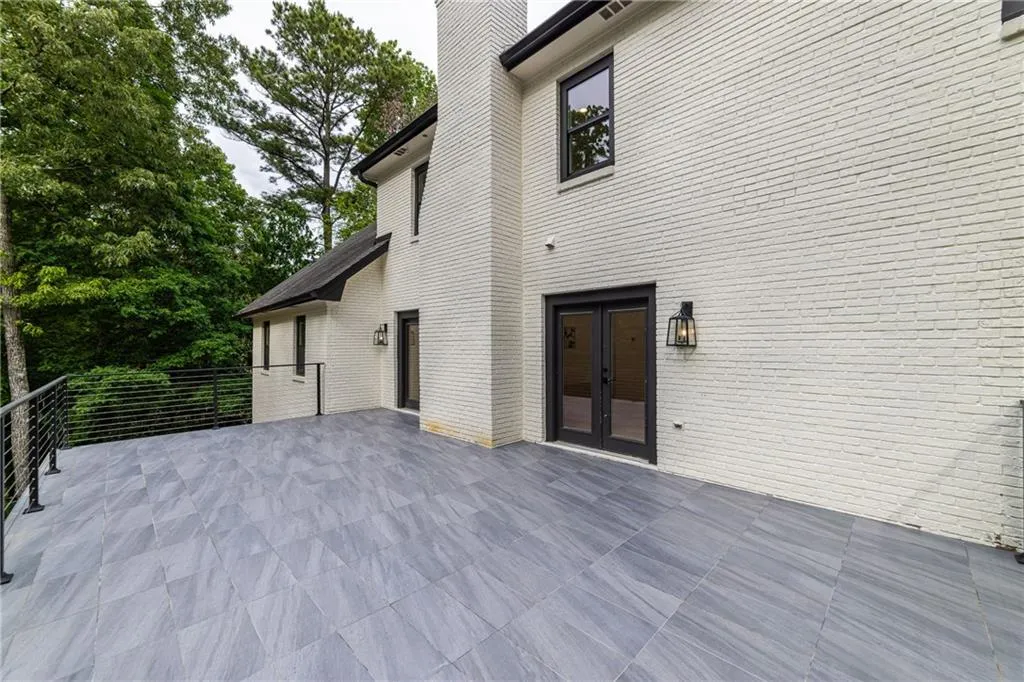 Wooden terrace featuring french doors and a patio
