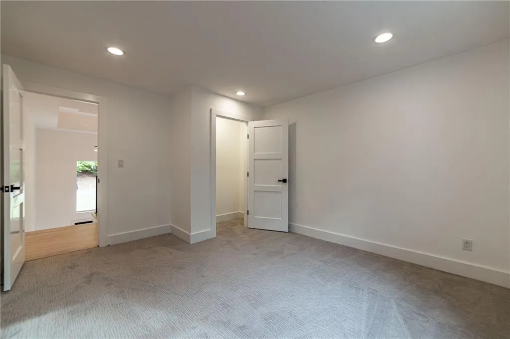 Carpeted empty room with recessed lighting