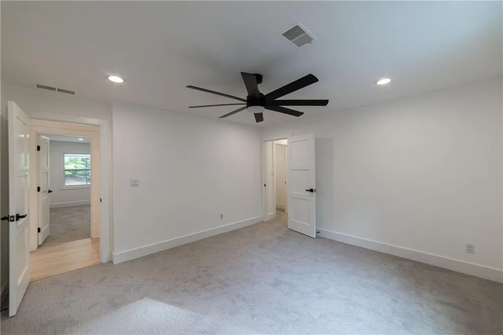 Unfurnished bedroom featuring light colored carpet, recessed lighting, and ceiling fan