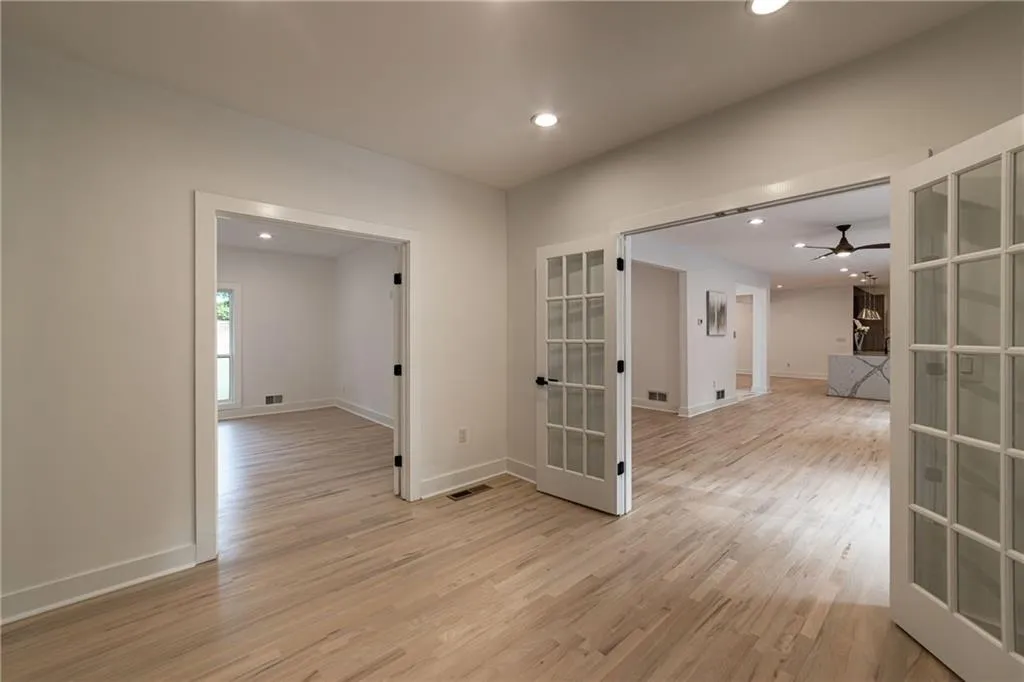 Empty room featuring recessed lighting, french doors, light wood finished floors, and ceiling fan
