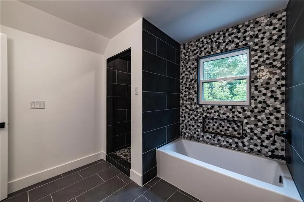 Bathroom with a bath, tile patterned flooring, and a shower