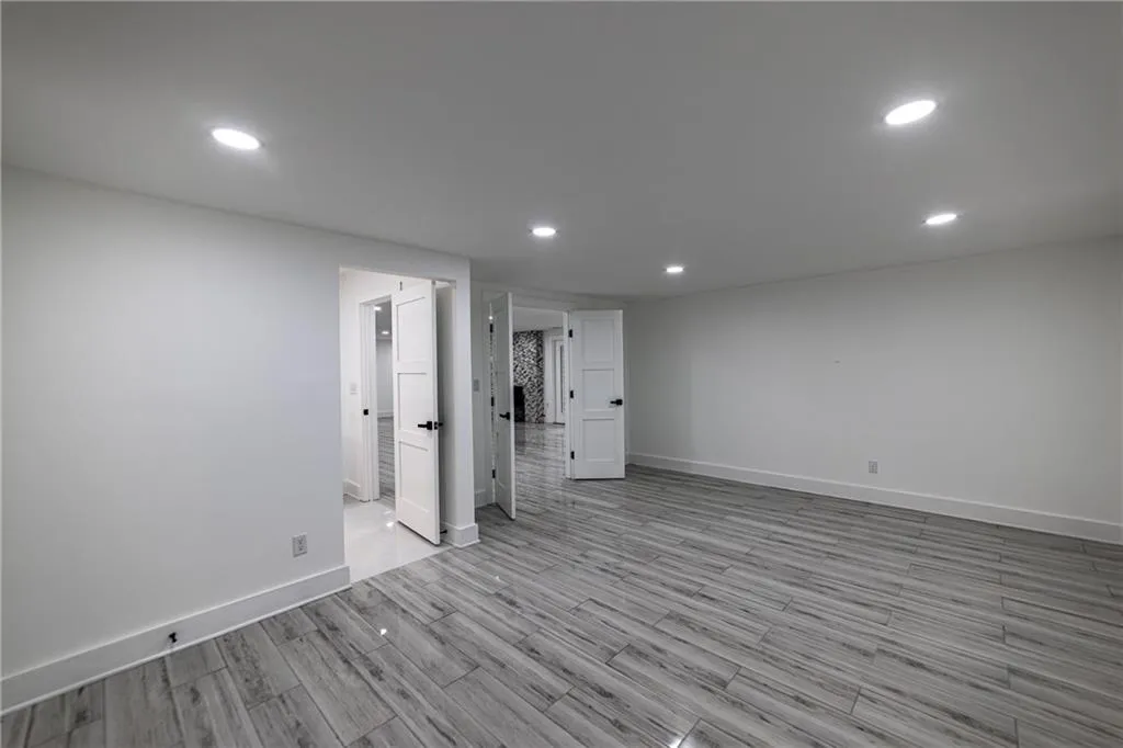Below grade area with recessed lighting and light wood-type flooring