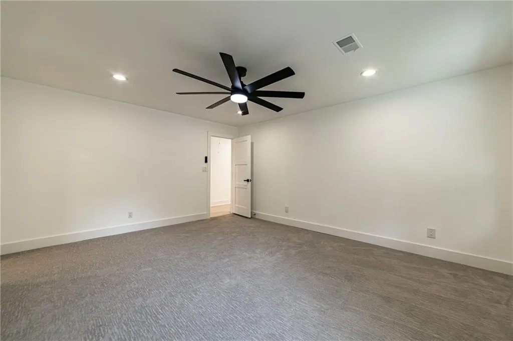 Unfurnished room featuring dark carpet, recessed lighting, and ceiling fan