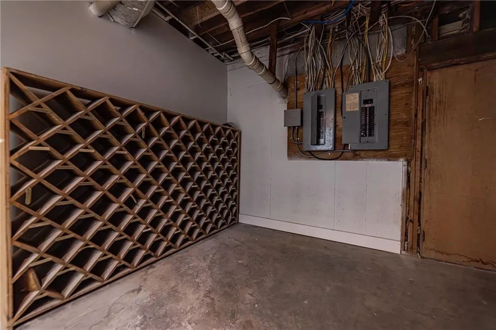 Wine area featuring concrete floors and electric panel