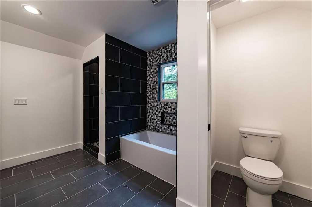 Bathroom with baseboards and tile patterned flooring