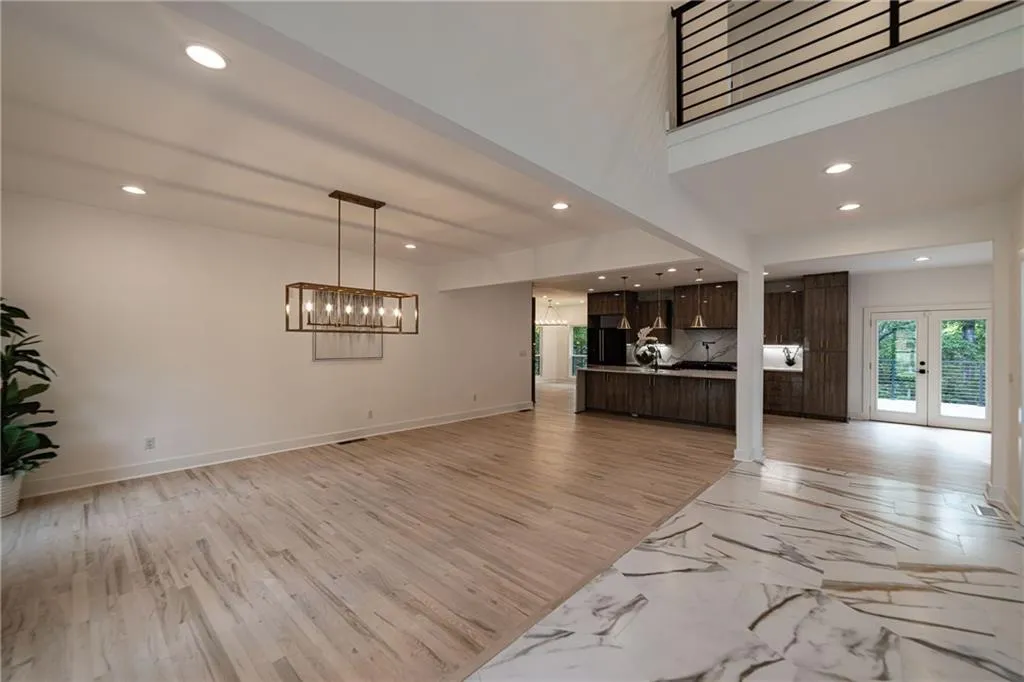 Unfurnished living room featuring recessed lighting, french doors, and light wood-type flooring
