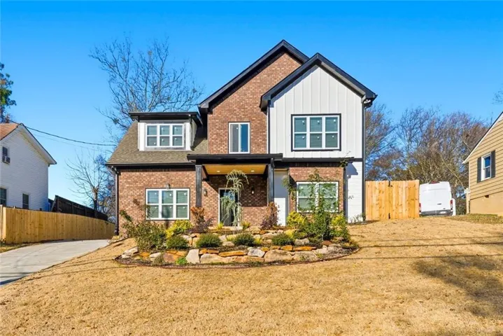 Craftsman house featuring board and batten siding and brick siding