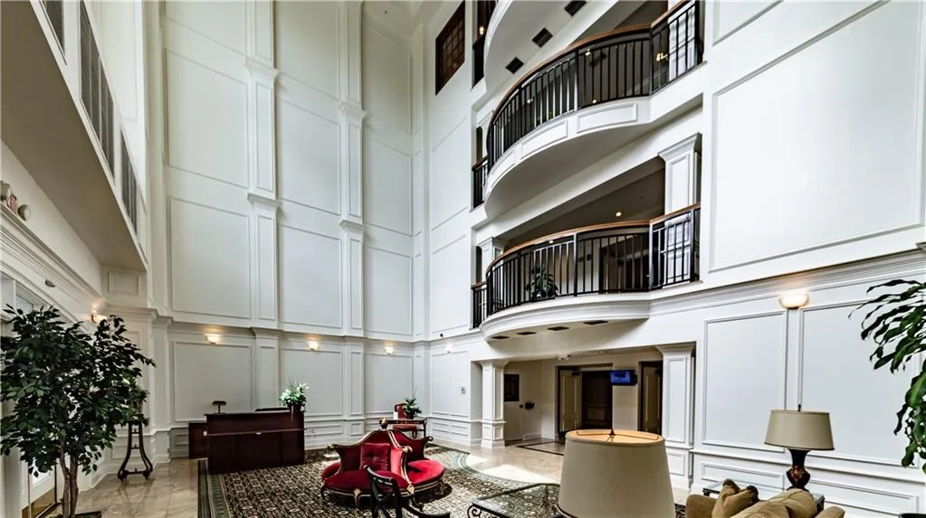 Community lobby featuring a decorative wall and a high ceiling