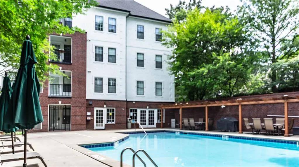 Community pool with a patio area and french doors