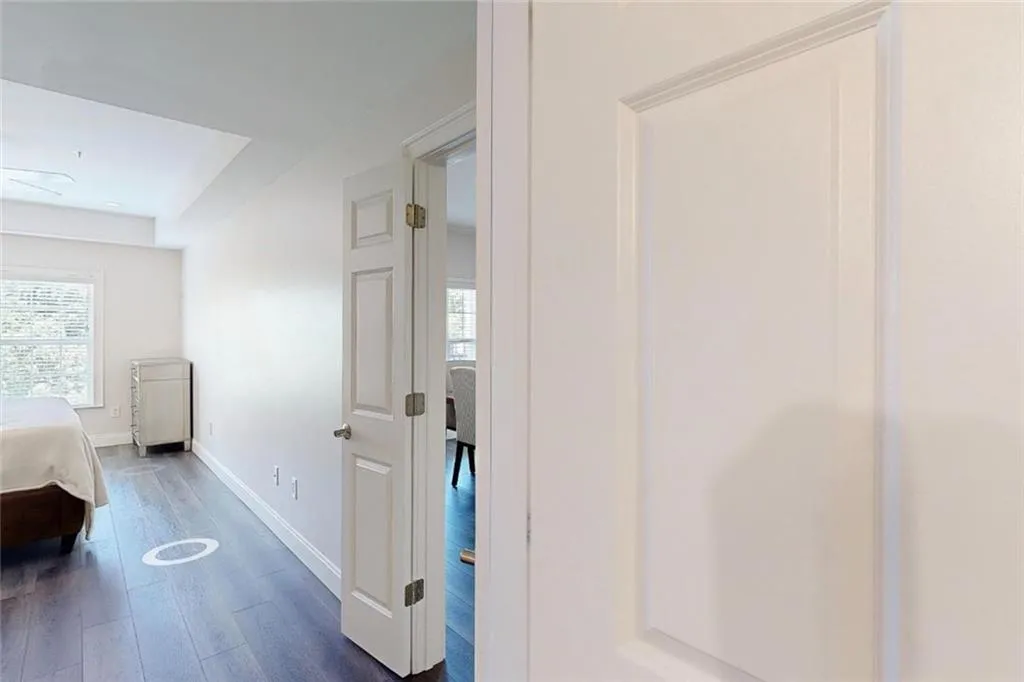 Hall with plenty of natural light and dark wood finished floors
