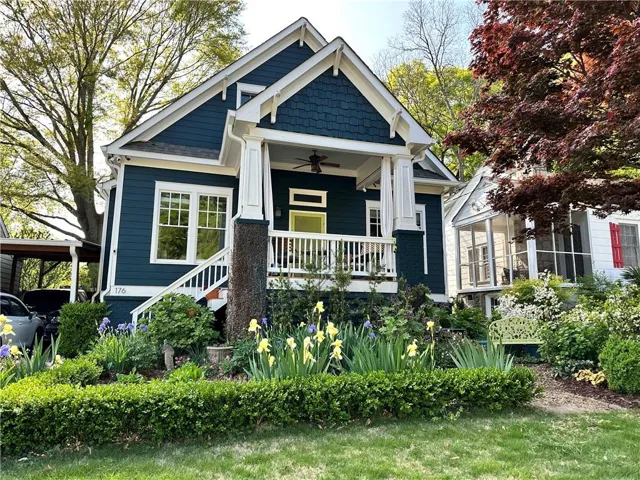 Craftsman-style home featuring a deep blue exterior with white trim