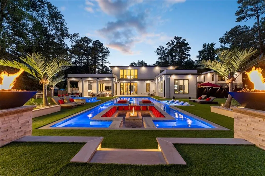 Oversized resort style backyard with ambient lighting, fire bowls, sunken fire put and more!