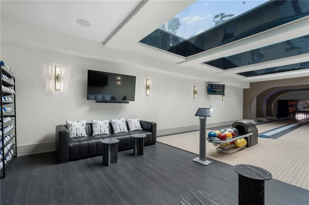 Two 50' bowling alley lanes with glass bottom swimming pool above